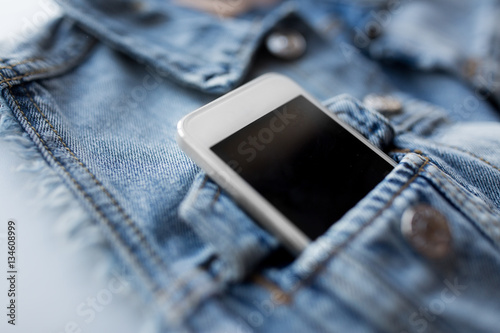 smartphone in pocket of denim jacket or waistcoat