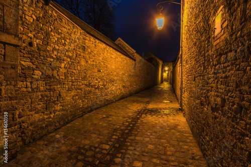 Valokuvatapetti Old french mediewal cobbled street in Carentan,France