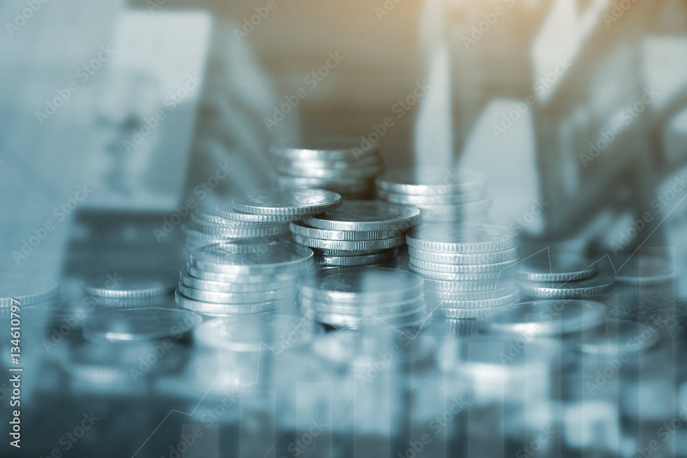 Double exposure of city and rows of coins for finance and banking concept Double exposure of city and rows of coins for finance and banking concept