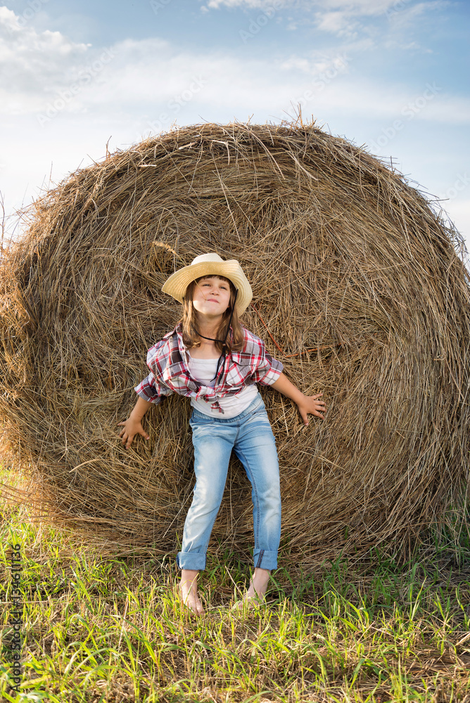 Cute Child having fun outdoors, little girl cowboy playing in wheat field at sunset. Happy baby girl with toy gun and cowboy hat enjoying nature. American Cowgirl. lovely smiling toddler portrait. Cute Child having fun outdoors, little girl cowboy playing in wheat field at sunset. Happy baby girl with toy gun and cowboy hat enjoying nature. American Cowgirl. lovely smiling toddler portrait.