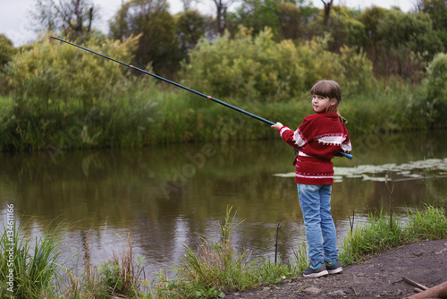 little girl fishing on the fishing rod