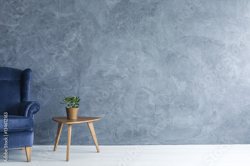 Blue armchair and wood side table photo