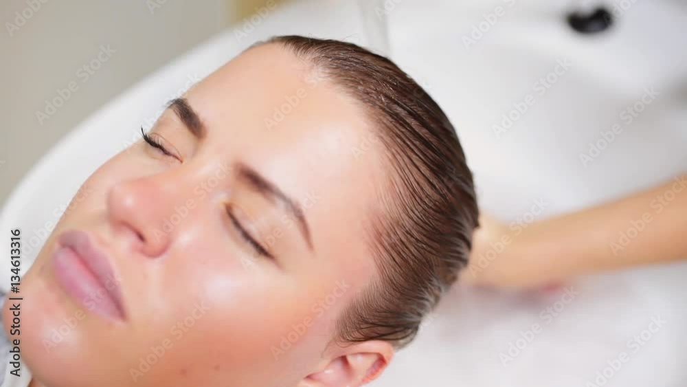 Hairdresser washes woman's hair in the beauty studio,spa and healthy mask for hair, beauty treatment, woman in spa beauty salon Hairdresser washes woman's hair in the beauty studio,spa and healthy mask for hair, beauty treatment, woman in spa beauty salon