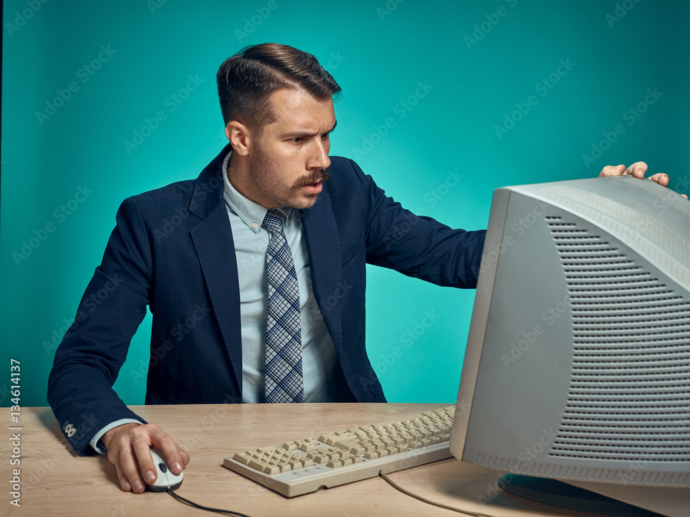 Surprised Young Man Working On computer At Desk Surprised Young Man Working On computer At Desk