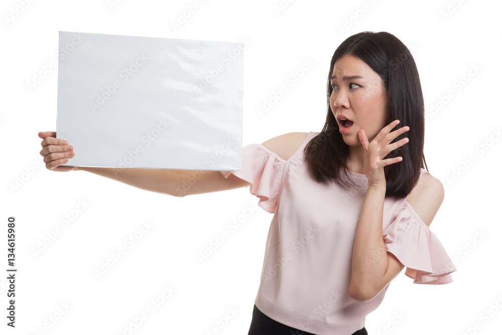 Young Asian business woman surprise with white blank sign. Young Asian business woman surprise with white blank sign.