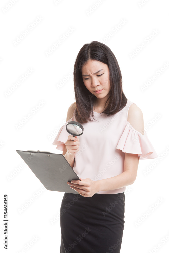 Young Asian business woman with a magnifying glass check report. Young Asian business woman with a magnifying glass check report.