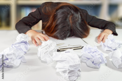 Stressed business woman make a mistake with chewed resume paper.