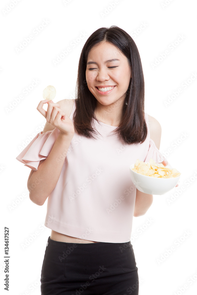 Young Asian woman eat potato chips. Young Asian woman eat potato chips.