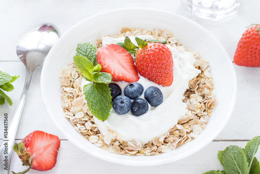 Morning healthy breakfast with muesli and berries on the white background. Top view Morning healthy breakfast with muesli and berries on the white background. Top view