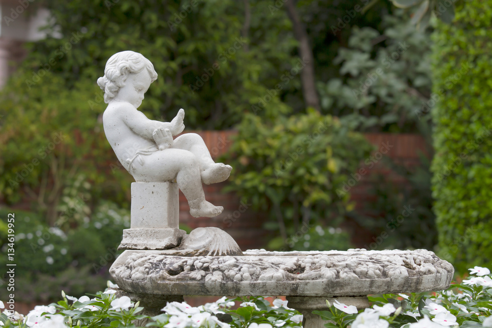 Obraz premium Statue Sculpture in public garden on tree background