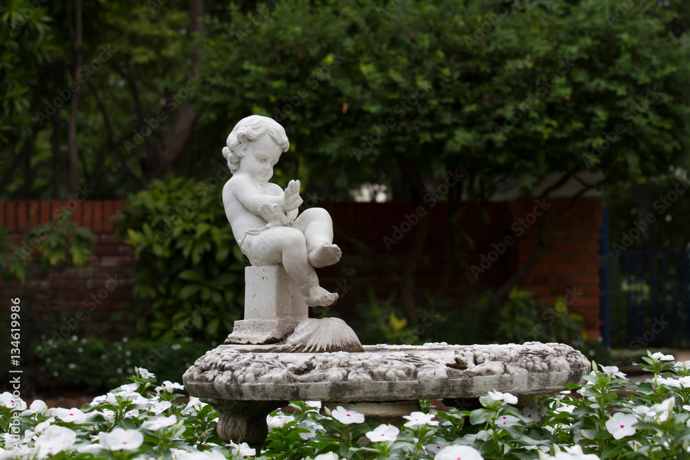 Statue Sculpture in public garden on tree background Statue Sculpture in public garden on tree background