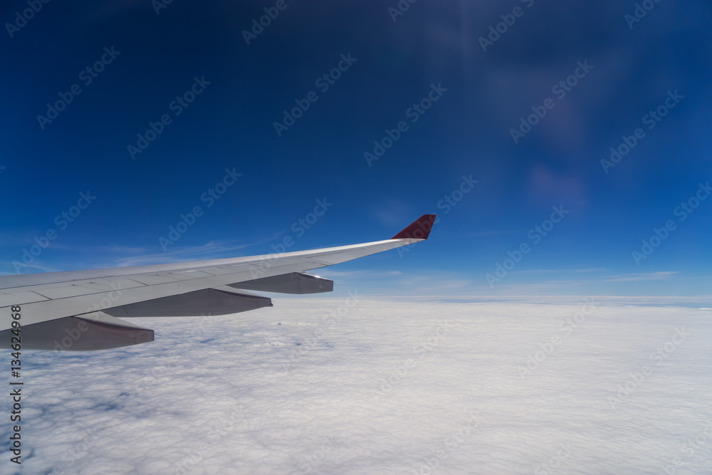 abstract wing of airplane on blue sky with cloudscape - can use to display or montage on product abstract wing of airplane on blue sky with cloudscape - can use to display or montage on product