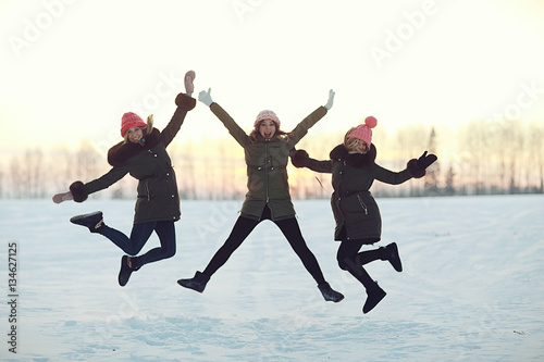 group of girls winter nature fun jump