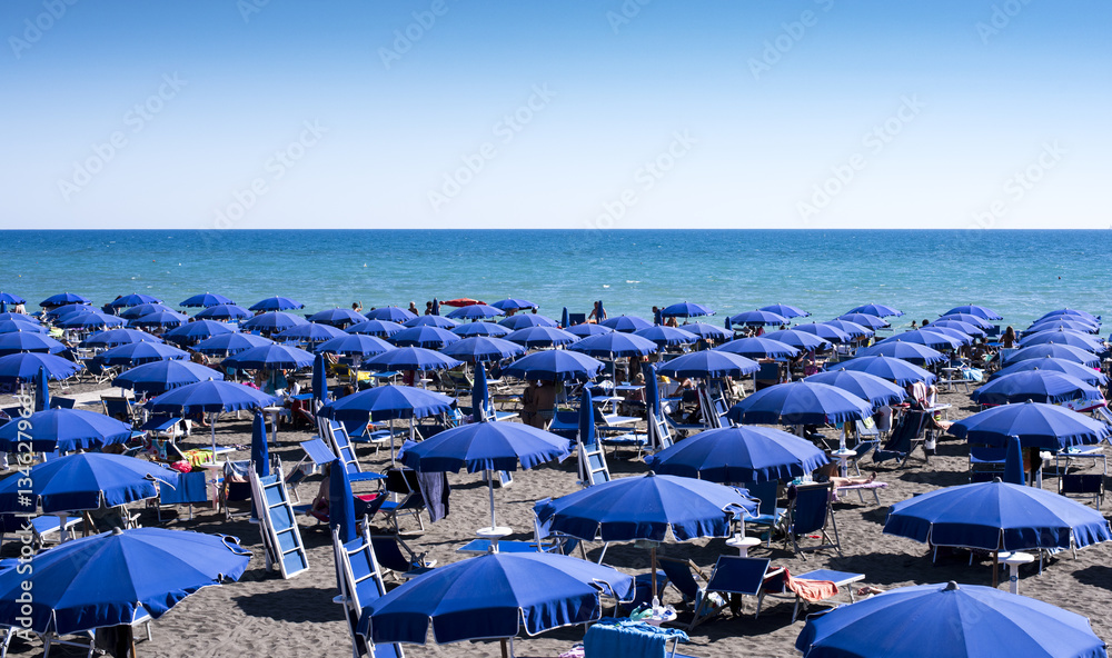beach full of umbrellas in the Mediterranean Sea in Italy