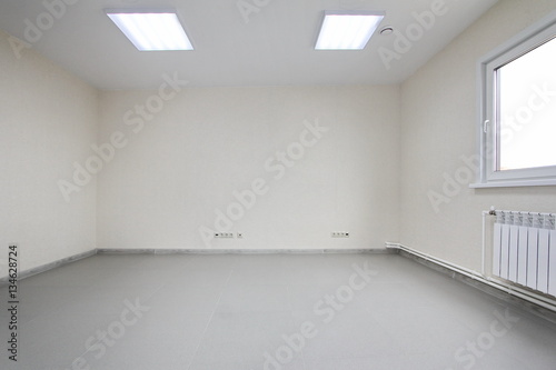 Interior empty office light room with white wallpaper unfurnished in a new building