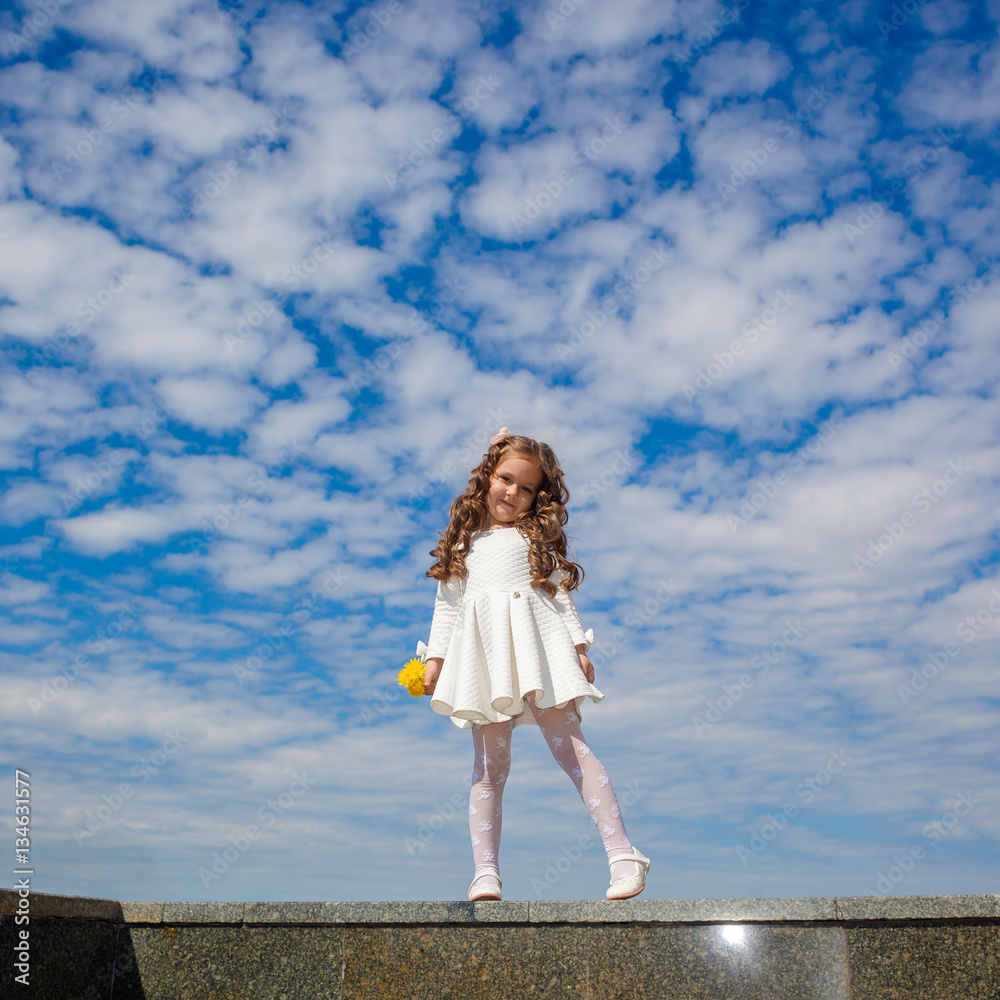 little girl in the clouds. little girl walks among the clouds. dreamy and fantasy concept little girl in the clouds. little girl walks among the clouds. dreamy and fantasy concept