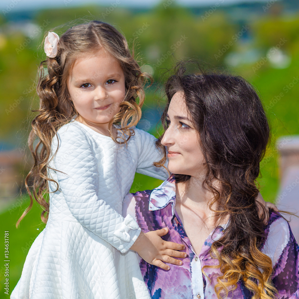 Fototapeta premium little girl hugging her mother emotionally