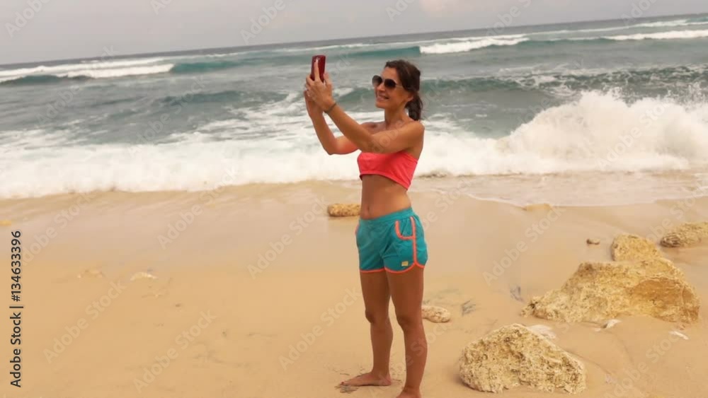 Young woman taking selfie photo with cellphone on beach, super slow motion 240fps
Young woman taking selfie photo with cellphone on beach, super slow motion 240fps