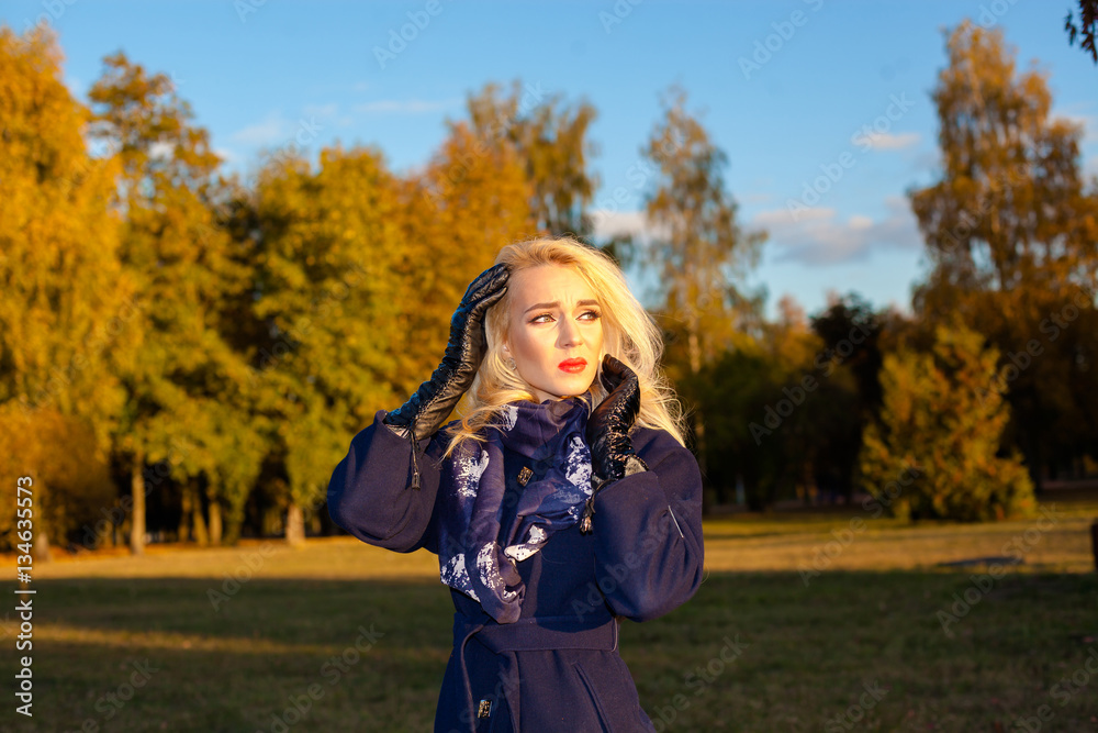 sad woman with a headache outdoors in autumn sad woman with a headache outdoors in autumn