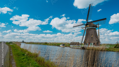 Windmill turbine energy and water lake scenery background. photo