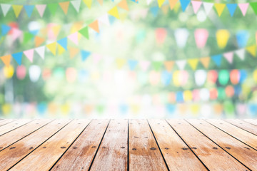 Empty wooden table with party in garden background blurred.
