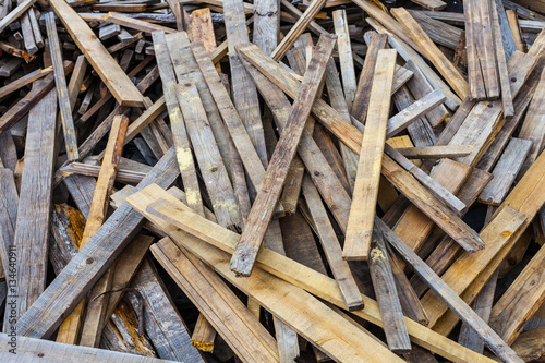Pile of old used timber planks. Landfill of wooden slats bad