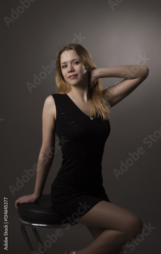 blonde on the chai,girl sitting on bar stool,girl sitting in high chair,girl in black dress sitting on chair,beautiful feet girls,