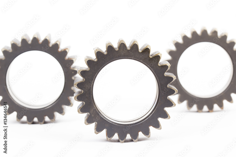 Small group of gears with their teeth engaged on a white background. Small group of gears with their teeth engaged on a white background.