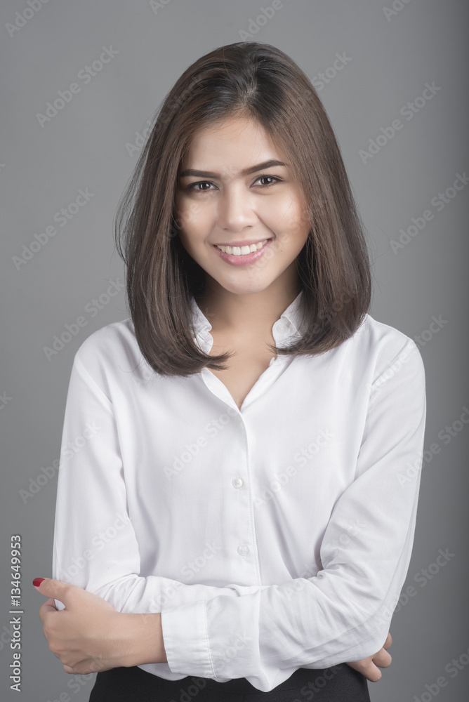 Beautiful Business Woman smiling on grey background Beautiful Business Woman smiling on grey background
