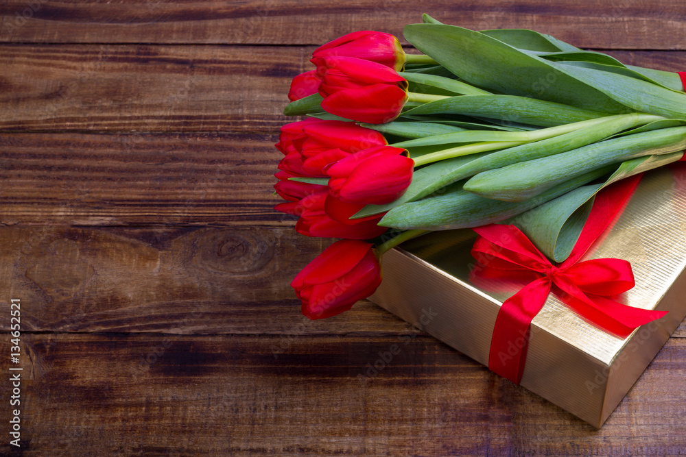 bouquet of red tulips and gift box