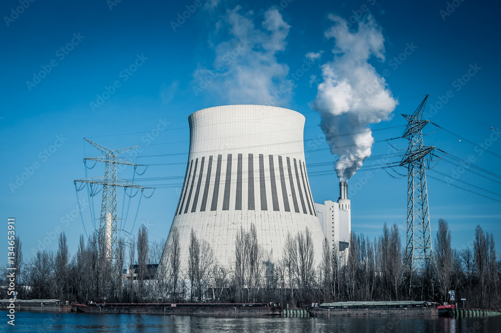 Cooling tower and smoke pipe of a heat and power plant against blue sky