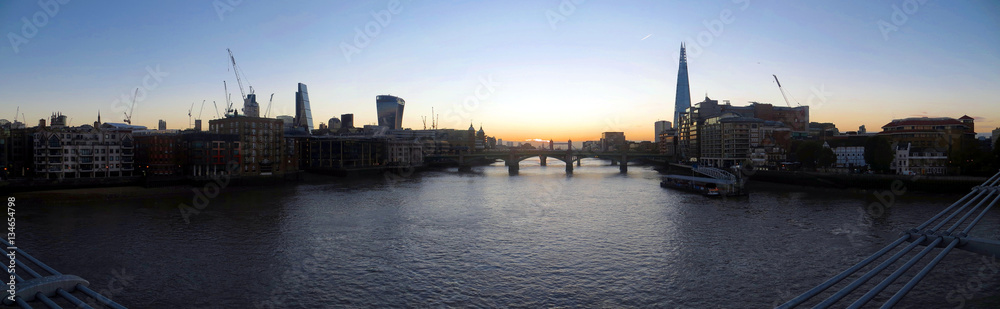 Look to the East on Millenium Bridge during Sunrise in London with Tower Bridge and the Shard