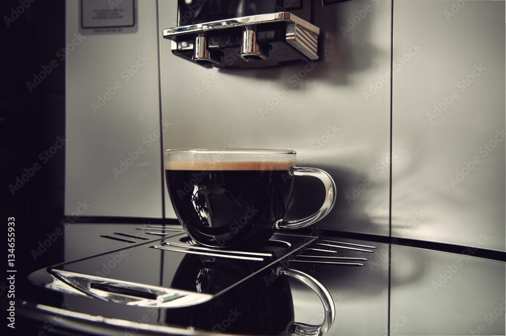 coffee in a glass cup on a modern coffee machine, vintage filtered style coffee in a glass cup on a modern coffee machine, vintage filtered style