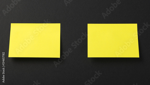 Two yellow post-it on black background