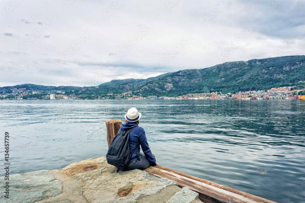 Girl sitting near the sea alone