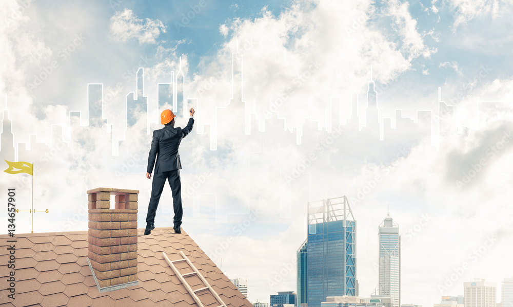 Man architect draw silhouette of modern city on blue sky. Mixed Man architect draw silhouette of modern city on blue sky. Mixed