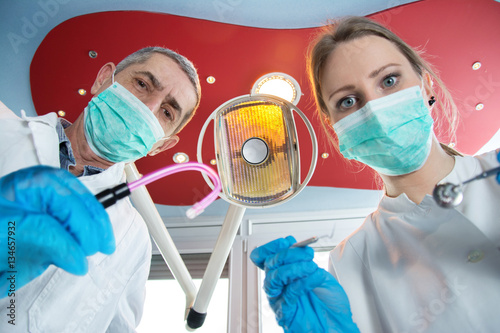 Low angle view of dentist and dental nurse.