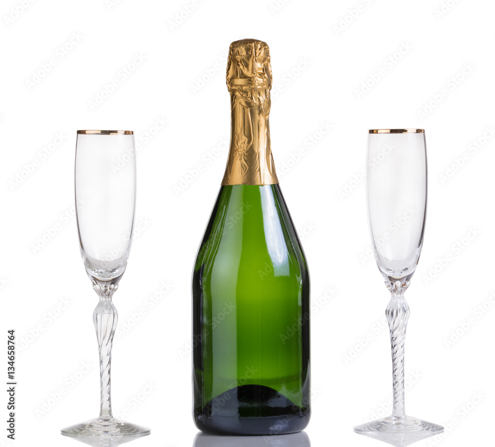 Unopened bottle of champagne and drinking glasses on white Unopened bottle of champagne and drinking glasses on white