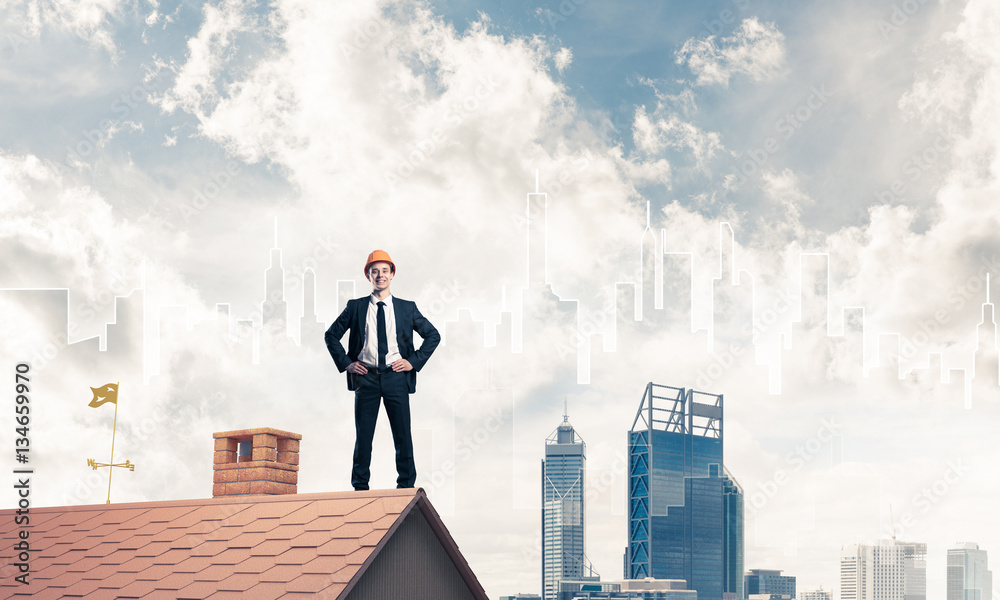 Engineer man standing on roof and looking away. Mixed media Engineer man standing on roof and looking away. Mixed media