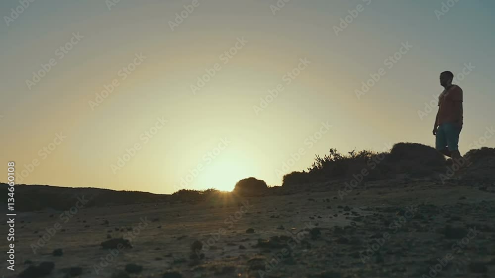 Men Walking down hill. Sunset Silhouette. Slow motion. Men Walking down hill. Sunset Silhouette. Slow motion.