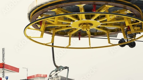 Frozen chair lift mechanism in mountains, selective focus