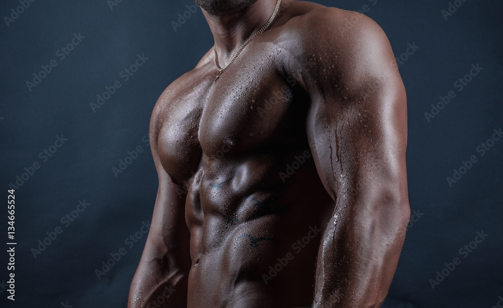 Handsome bodybuilder torso with drops of water on it