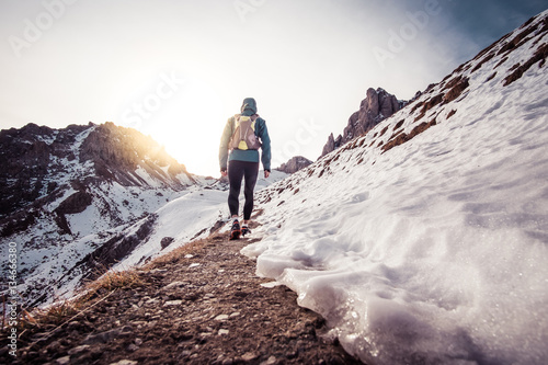 Man running on the snow on a mountain photo