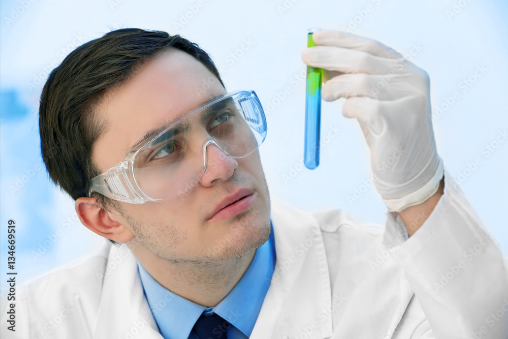 Young male scientist making experiments in laboratory Young male scientist making experiments in laboratory