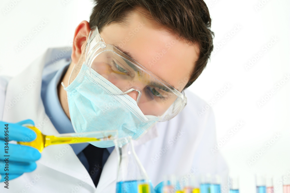 Young male scientist making experiments in laboratory Young male scientist making experiments in laboratory
