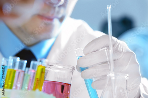 Young male scientist making...