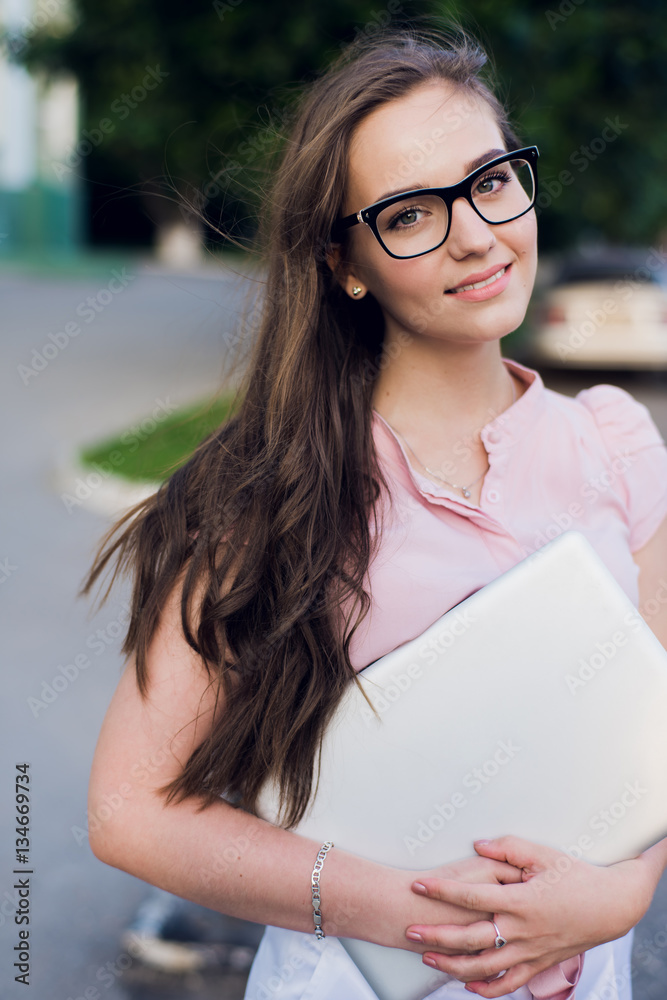 Shot of a happy young woman holding a laptop outside Shot of a happy young woman holding a laptop outside