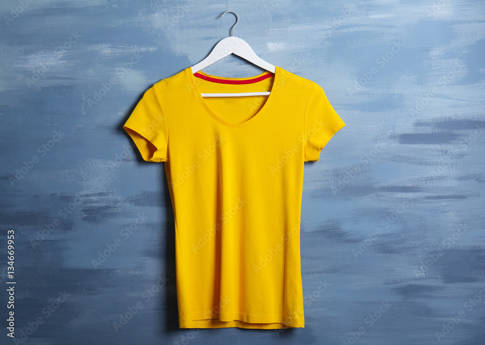 Blank yellow t-shirt against grunge background Blank yellow t-shirt against grunge background