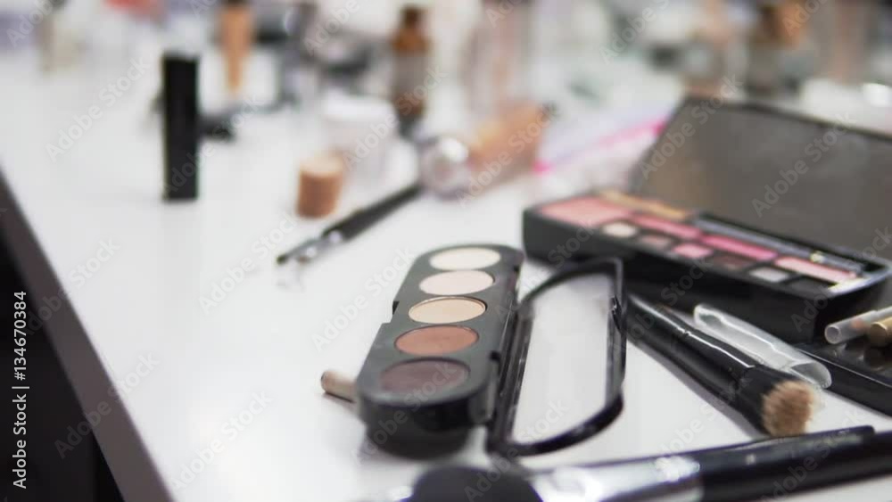 Make up artist accessories are gradually revealed as the camera slowly tilts down. Make up artist accessories are gradually revealed as the camera slowly tilts down.