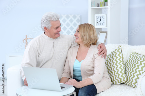 Grandparents using laptop a...
